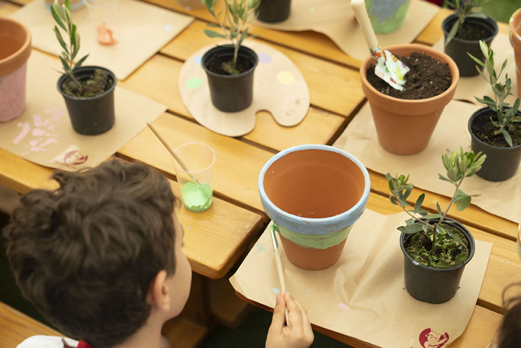 a kid painting a pot